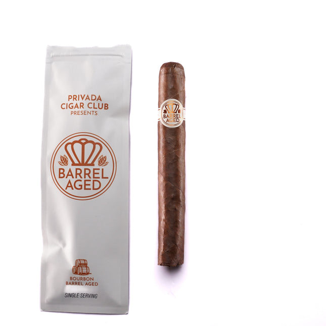 Cigar and packaging with 'Privada Cigar Club' branding on a white background