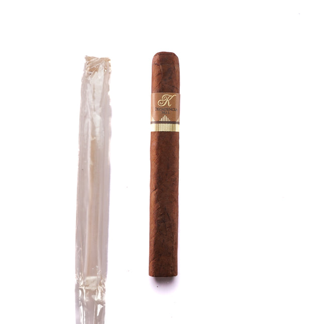 Cigar with a branded cap next to a clear plastic wrapper on a white background