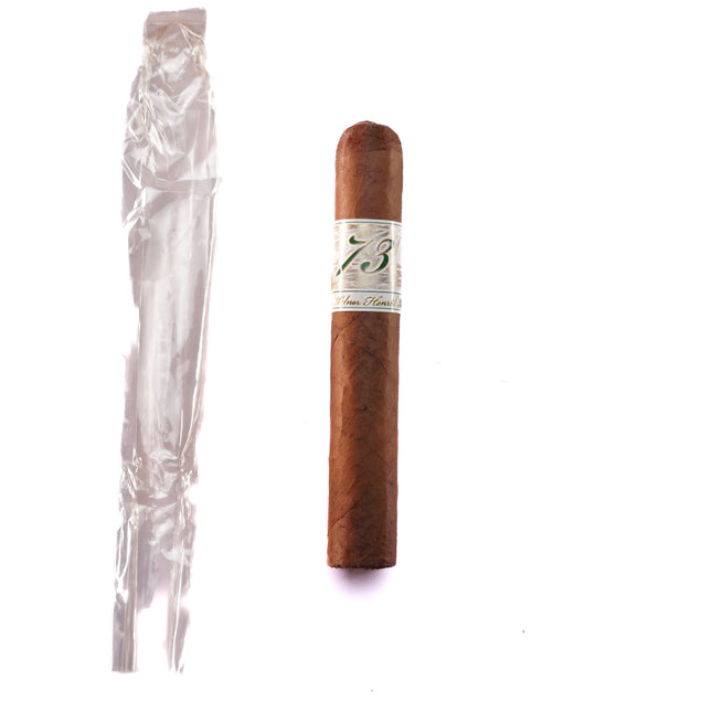 Cigar with a label next to a clear plastic wrapper on a white background