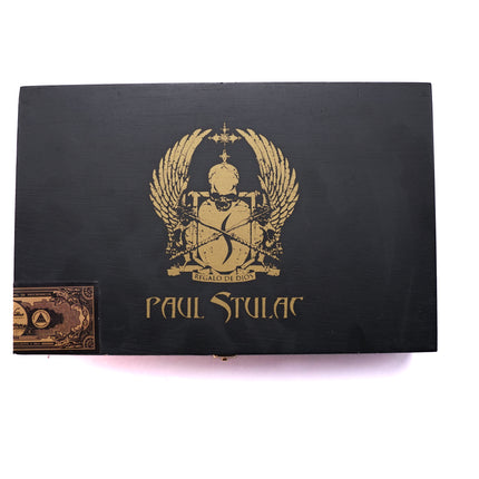 Black box with gold emblem and 'Paul Stulac' branding on a white background