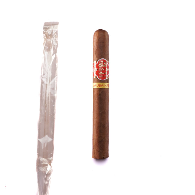 Cigar and a half-emptied plastic wrapper on a white background