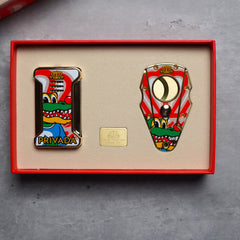 Two colorful pins in a red box on a gray surface